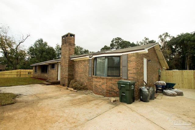 view of side of home with a patio area