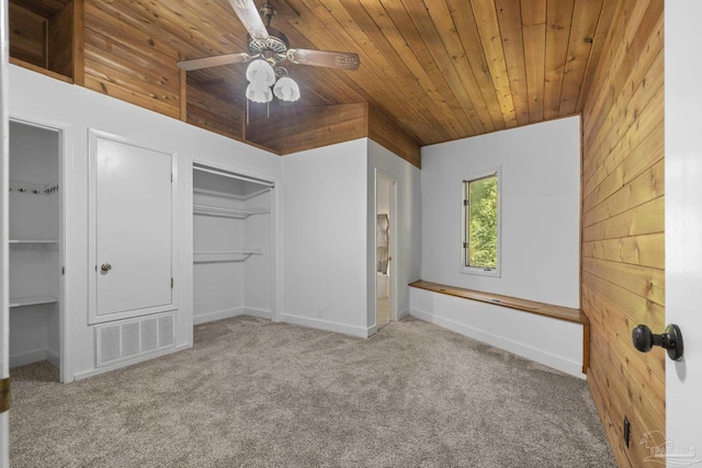 1221 Tecumseh Pl, Pensacola, FL 32514 - unfurnished bedroom featuring wooden ceiling, carpet, wood walls, a closet, and a ceiling fan