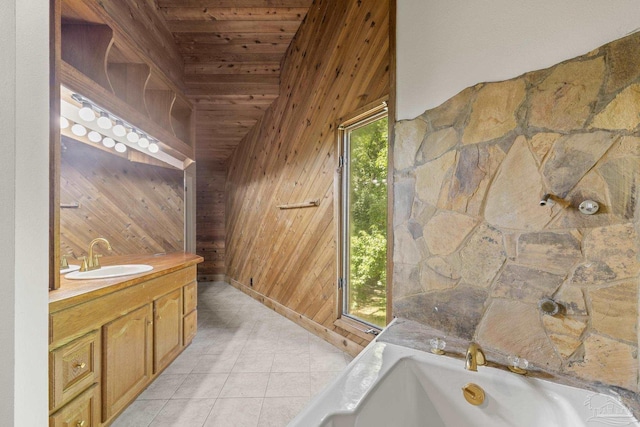 1221 Tecumseh Pl, Pensacola, FL 32514 - bathroom featuring wood walls, vanity, tile patterned floors, wooden ceiling, and a bathtub