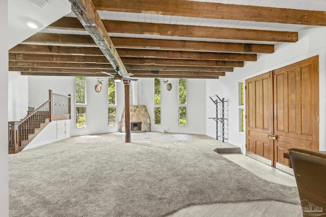 1221 Tecumseh Pl, Pensacola, FL 32514 - unfurnished living room with beam ceiling, plenty of natural light, a ceiling fan, and stairway
