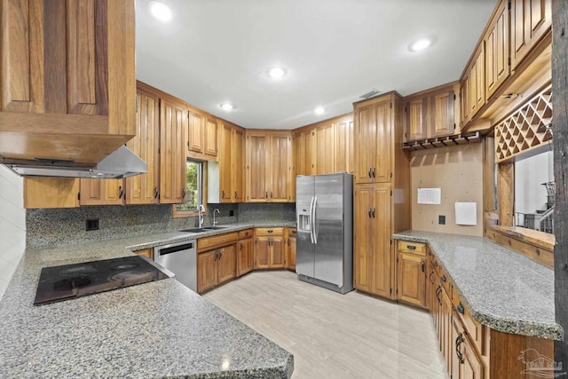 1221 Tecumseh Pl, Pensacola, FL 32514 - kitchen with appliances with stainless steel finishes, brown cabinetry, decorative backsplash, recessed lighting, and light stone counters