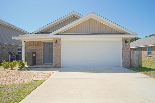 view of front of home with a garage and central AC unit