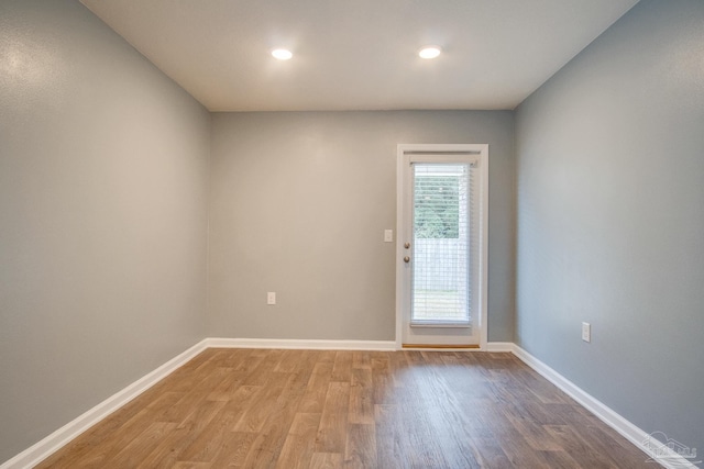 doorway with hardwood / wood-style flooring