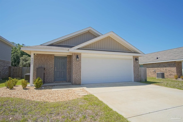 view of front of house with a front lawn, a garage, and central AC unit