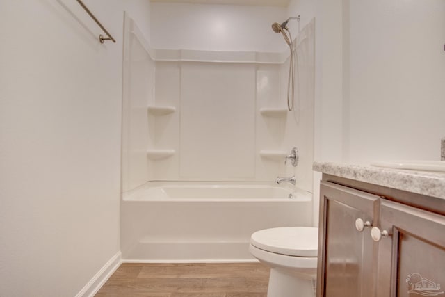 full bathroom featuring hardwood / wood-style floors, vanity, toilet, and shower / tub combination