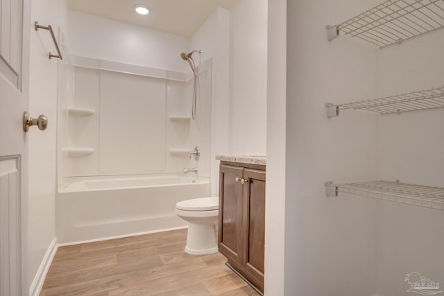 full bathroom with shower / tub combination, toilet, vanity, and hardwood / wood-style flooring