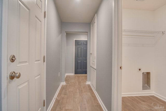 corridor with light hardwood / wood-style floors