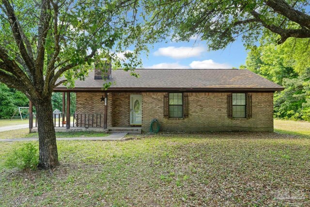 ranch-style home featuring a front lawn, brick siding, and a shingled roof