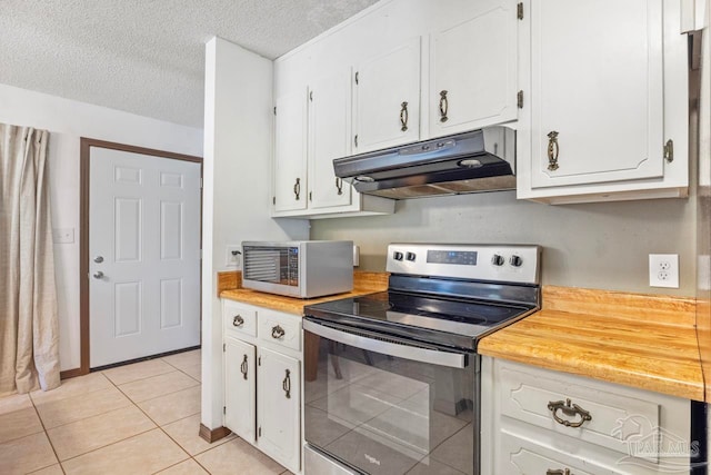kitchen featuring a textured ceiling, light tile patterned floors, stainless steel appliances, white cabinets, and under cabinet range hood