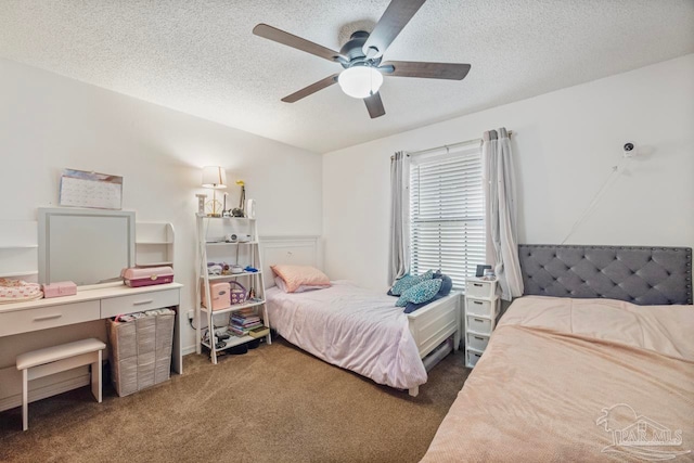 carpeted bedroom with a textured ceiling and ceiling fan