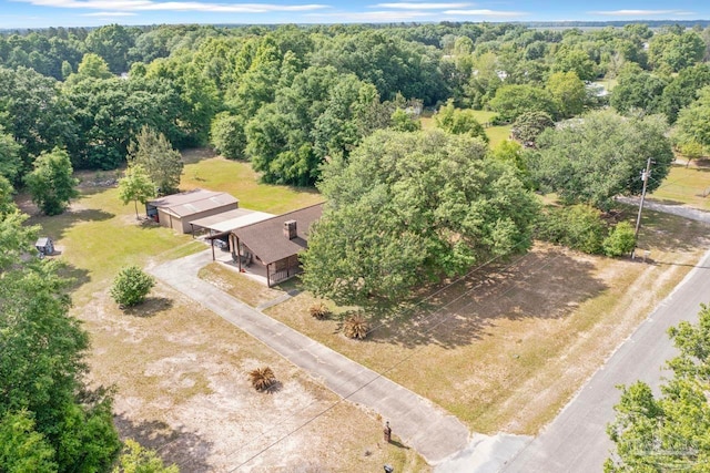 birds eye view of property with a forest view