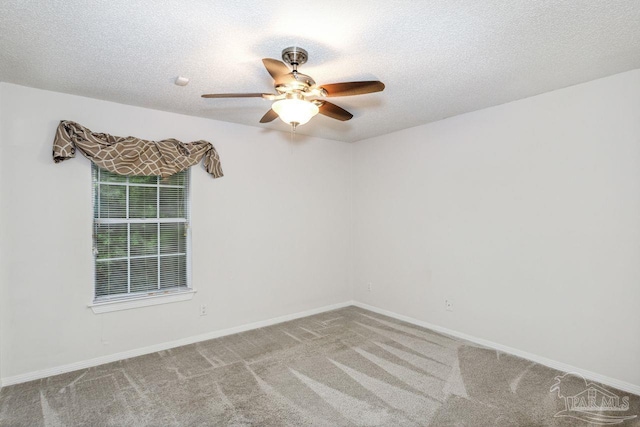 empty room featuring a textured ceiling, ceiling fan, and carpet flooring