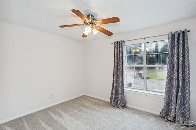 carpeted empty room featuring a textured ceiling and ceiling fan