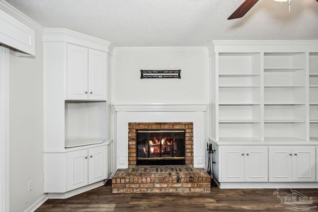 unfurnished living room featuring a textured ceiling, a brick fireplace, and ceiling fan