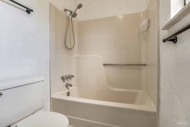 bathroom featuring bathtub / shower combination and toilet