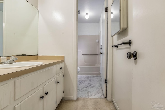 bathroom featuring tile patterned flooring, toilet, and vanity