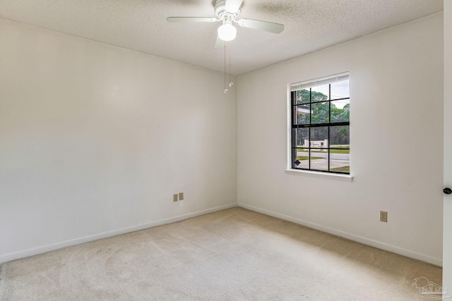 carpeted empty room with a textured ceiling and ceiling fan