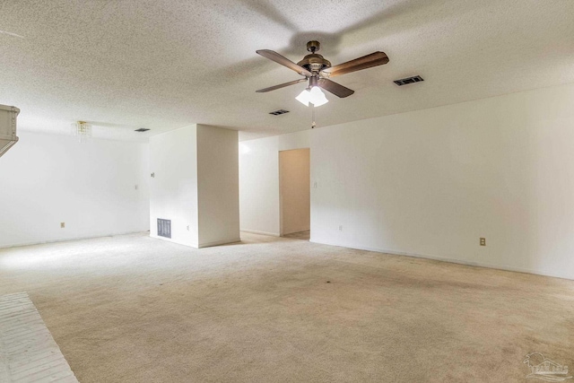 carpeted empty room featuring a textured ceiling and ceiling fan