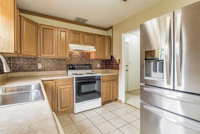 kitchen featuring decorative backsplash, stainless steel refrigerator with ice dispenser, sink, light tile patterned floors, and white electric range