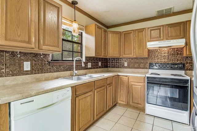 kitchen featuring sink, backsplash, pendant lighting, and white appliances