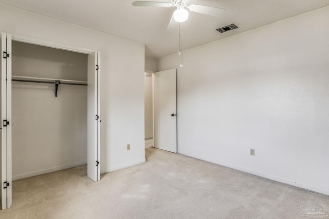 unfurnished bedroom with a closet, ceiling fan, and light colored carpet