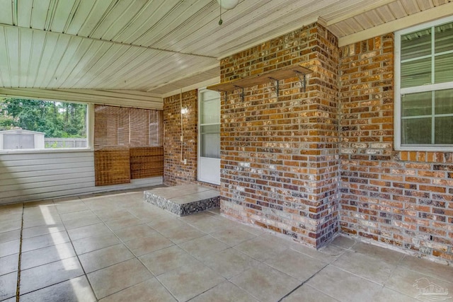 unfurnished sunroom with wood ceiling