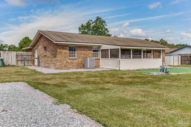 single story home with central air condition unit and a front lawn