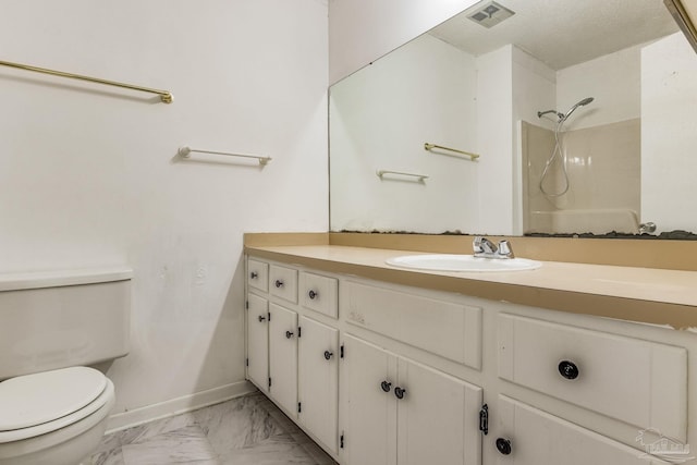 bathroom featuring toilet, tile patterned flooring, vanity, walk in shower, and a textured ceiling