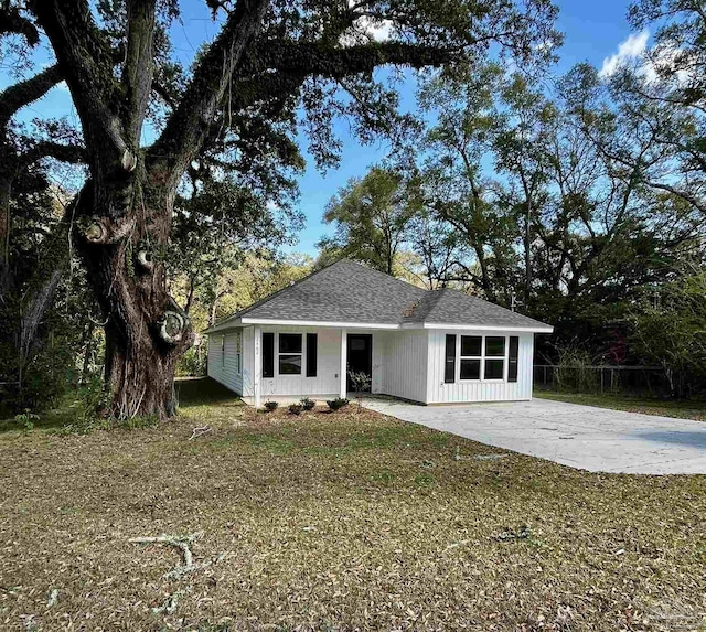 view of front of house with a patio and a shingled roof