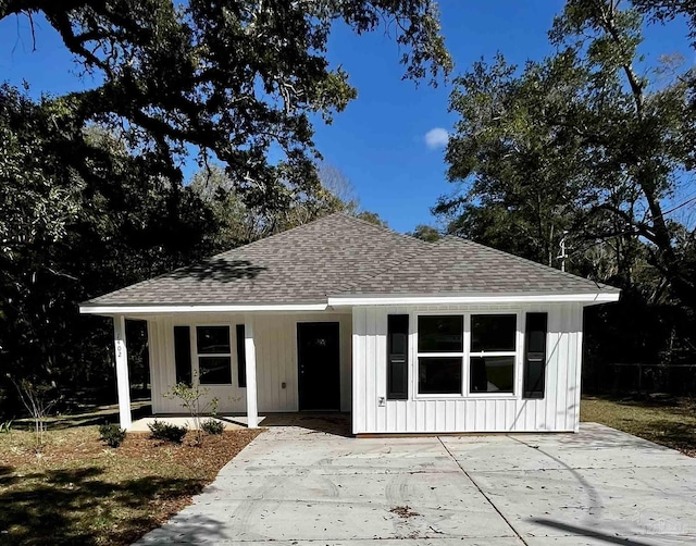 view of front of home featuring a porch, board and batten siding, and a shingled roof