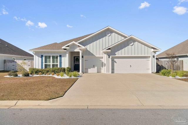 view of front facade featuring a garage, concrete driveway, board and batten siding, and fence