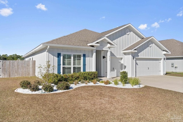 view of front of property with a shingled roof, concrete driveway, an attached garage, fence, and board and batten siding