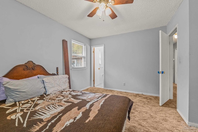 carpeted bedroom featuring ceiling fan and a textured ceiling