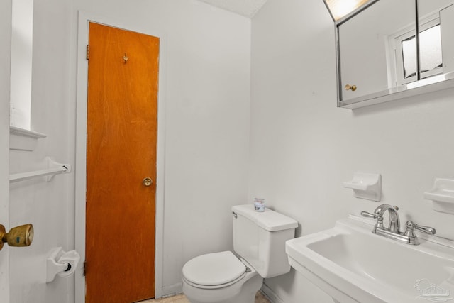 bathroom with sink and toilet