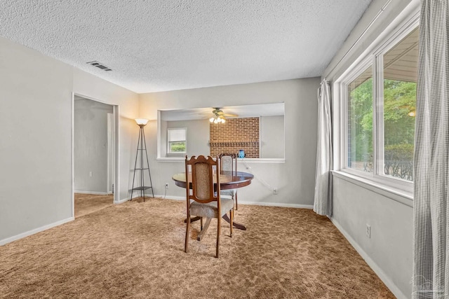 interior space featuring ceiling fan, a fireplace, and a textured ceiling