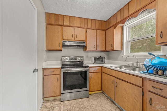 kitchen with sink, a textured ceiling, and electric range