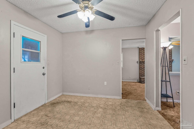 foyer featuring ceiling fan and a textured ceiling