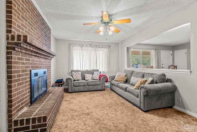 living room with a brick fireplace, carpet floors, a textured ceiling, and ceiling fan