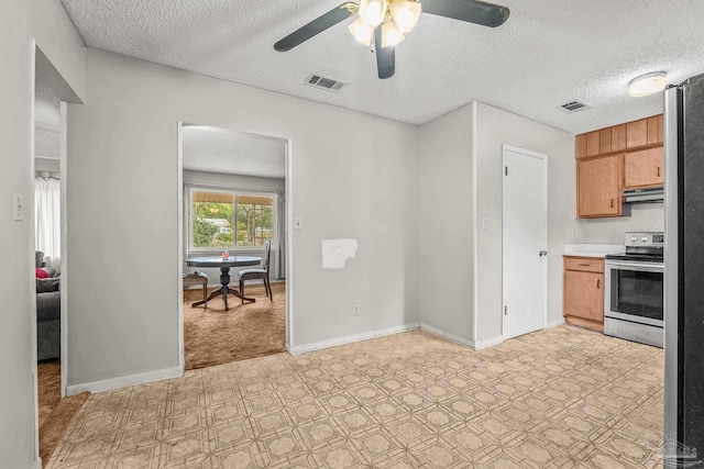 kitchen featuring ceiling fan, stainless steel electric stove, and a textured ceiling