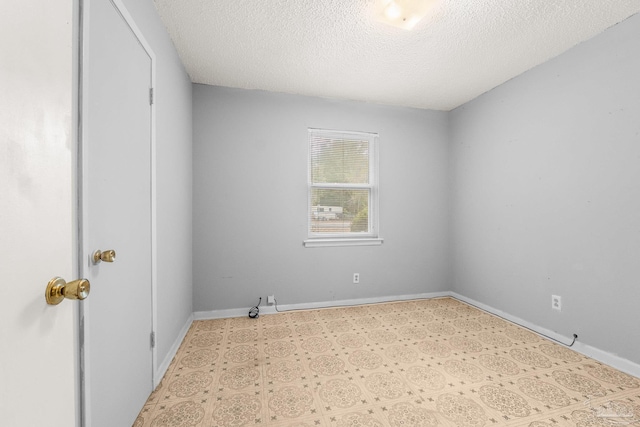 empty room featuring a textured ceiling