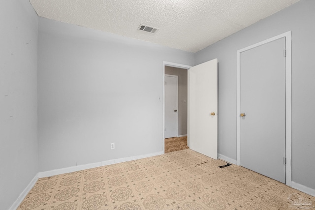 unfurnished bedroom featuring a textured ceiling