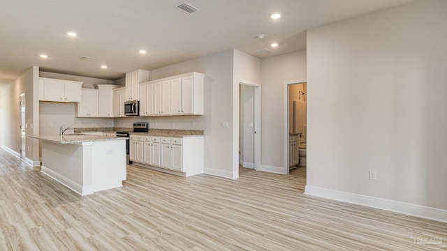 8616 Bluebell St, Milton, FL 32583 - kitchen featuring appliances with stainless steel finishes, light wood-style flooring, baseboards, recessed lighting, and white cabinetry