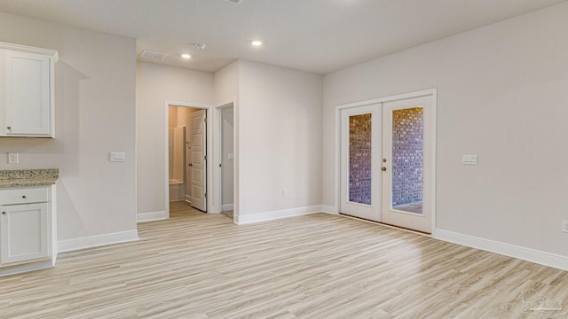 8616 Bluebell St, Milton, FL 32583 - spare room featuring french doors, light wood-style flooring, baseboards, and recessed lighting