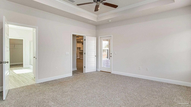 8616 Bluebell St, Milton, FL 32583 - unfurnished bedroom with carpet floors, a tray ceiling, crown molding, baseboards, and a ceiling fan