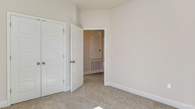 8616 Bluebell St, Milton, FL 32583 - unfurnished bedroom featuring light colored carpet, a closet, and baseboards