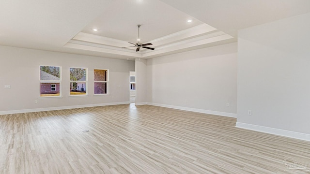8616 Bluebell St, Milton, FL 32583 - empty room featuring a raised ceiling, light wood-style floors, ceiling fan, baseboards, and recessed lighting