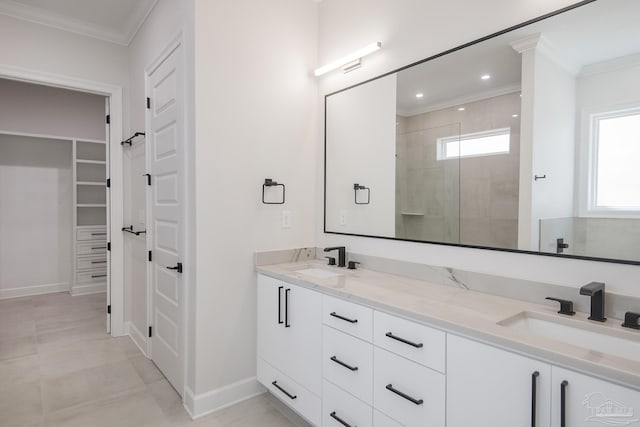 full bathroom featuring a walk in closet, ornamental molding, a tile shower, and a sink