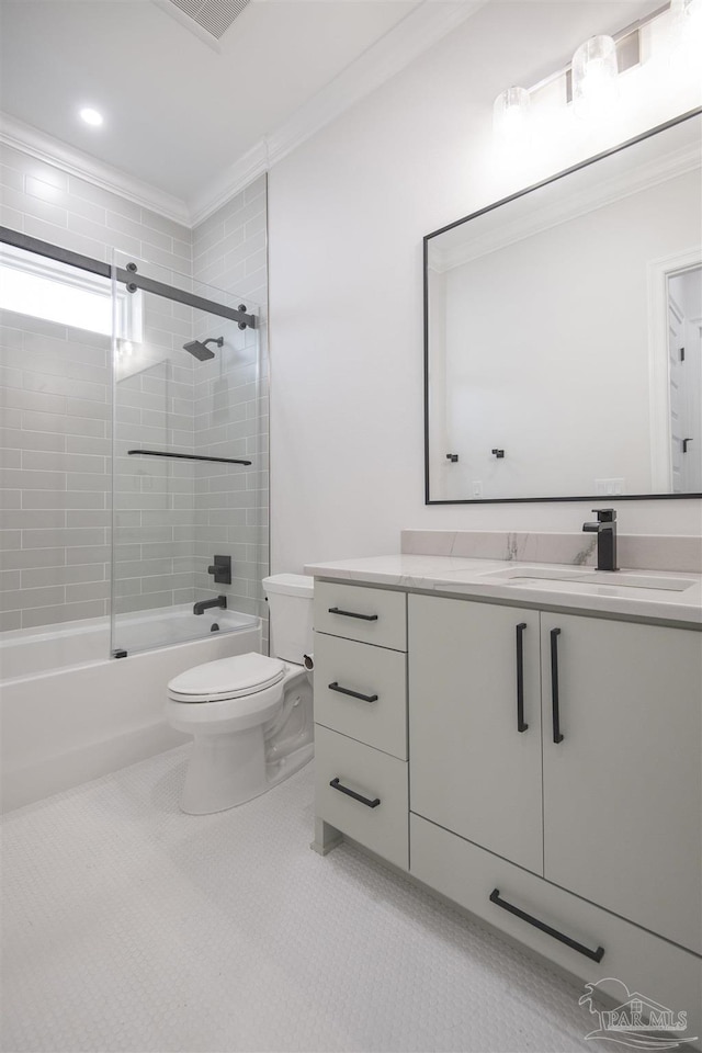 bathroom featuring vanity, ornamental molding, tile patterned flooring, shower / bathing tub combination, and toilet