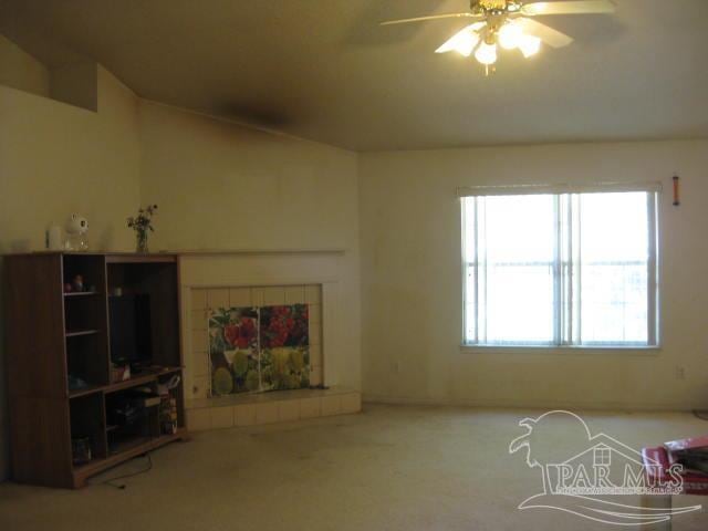 unfurnished living room featuring ceiling fan and carpet floors