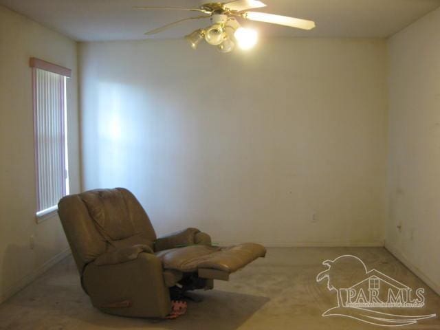 living area with ceiling fan and light colored carpet